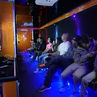 While the adults are watching the boxing match the children continue to play inside.