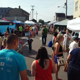 a crowd of people walking down the street