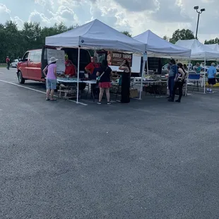 people standing under tents