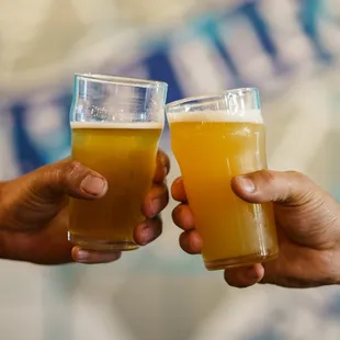 two men holding glasses of beer
