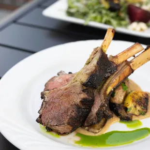 The best lamb loin - perfectly charred and accompanied by roasted eggplant sauce, smashed potato, and summer veggies