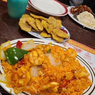 Latin style shrimp yellow rice fried green plantains with a Blue Hawaiian Pina colada! Drink was delicious &amp; strong.The food was delicious.