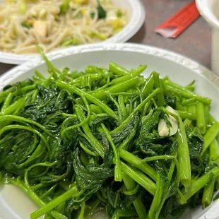 a plate of broccoli and noodles