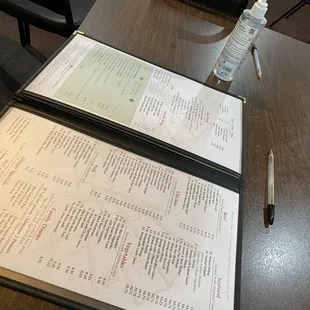 a menu and a bottle of water