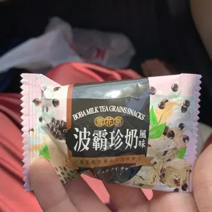 a hand holding a snack bar