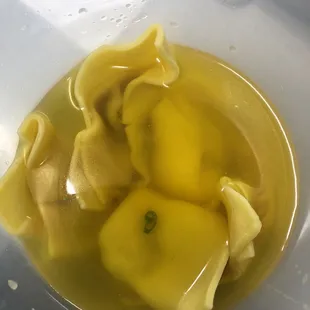 a bowl of soup with dumplings
