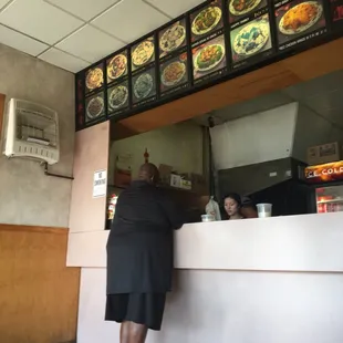 a woman ordering food at a restaurant