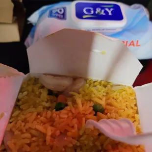 rice and vegetables in a paper container