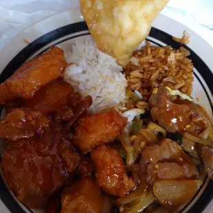 Clockwise from left: orange chicken, white rice, cheese puffs, fried rice, and mangolian beef