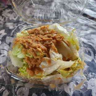 a salad in a plastic container