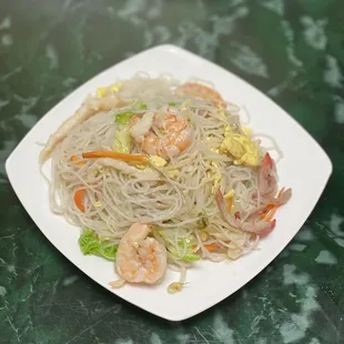a plate of noodles and shrimp