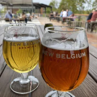 Patio with high tops and outdoor stage overlooking the river
