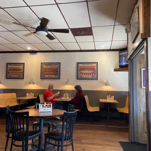 people sitting at tables in a restaurant