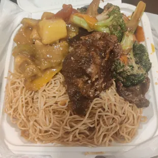 Too Good to Go order. Chow mein, probably beef and broccoli, curry chicken, and a piece of stewed or black pepper chicken?