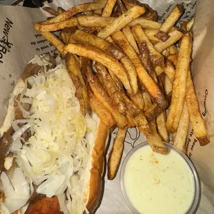 New Orleans cajun andouille Brat (added kraut and carmalized onions) with fries and side of melted pepper jack cheese
