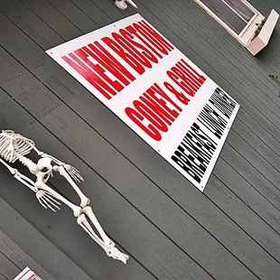 a skeleton and a sign