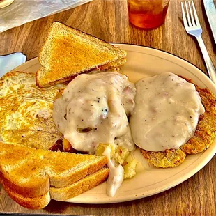 Country fried steak and fried potatoes with gravy, two eggs over easy and toast