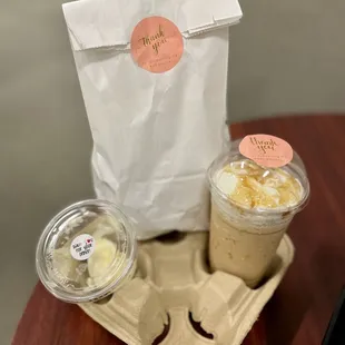 two cups of coffee and a bag of ice cream