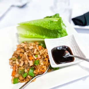 a plate of food with lettuce and sauce