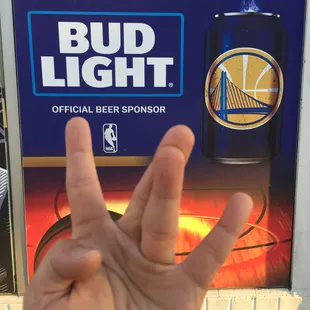 a hand holding a can of bud light