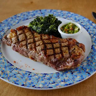 New York steak with sautéed spinach.