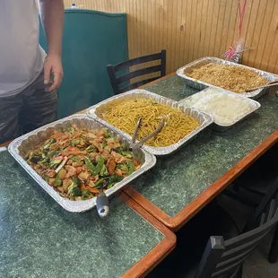 a man standing in front of a table full of food