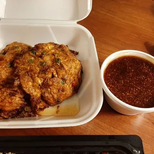 Egg foo young and sauce that accompanies the dish.