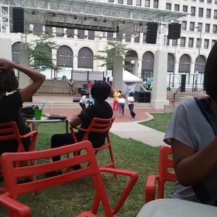 people sitting in red chairs