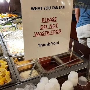 a sign stating that you can eat please do not waste food thank you