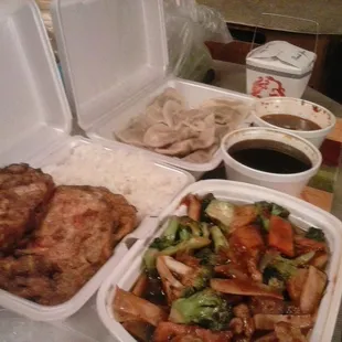 Roast pork egg foo young and sauce with white rice, Hunan chicken with white rice, and 8 steamed dumplings with dip.
