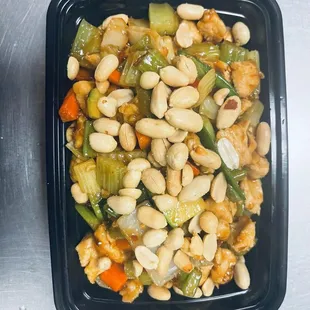 a black plastic container filled with beans and vegetables