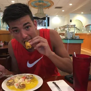 My son enjoying one of their great egg rolls