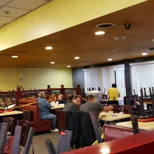 people sitting at tables and eating