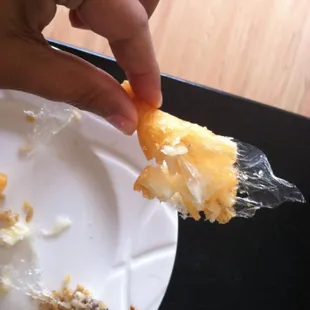 This is a piece of deep fried plastic found in my sweet and sour chicken!!! Don&apos;t eat here!!!