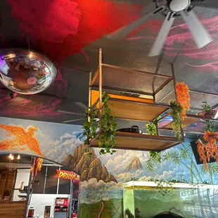 a ceiling mural with a mirror ball hanging from the ceiling