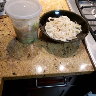 a bowl of noodles and a cup of soup