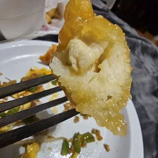 a piece of fried cauliflower on a fork