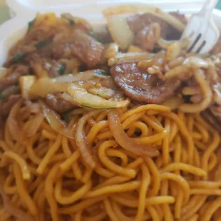 a plate of noodles and meat