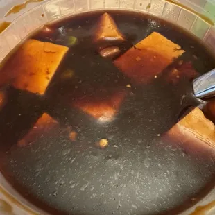 Mapo tofu in extremely dark soy based soup