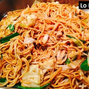 a bowl of noodles with meat and vegetables