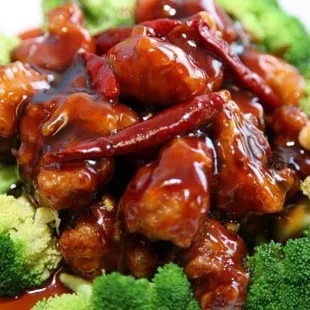a plate of chinese food with broccoli