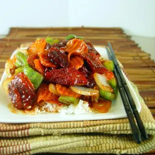 a plate of food with chopsticks