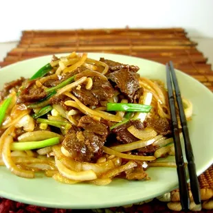 a plate of beef and noodles