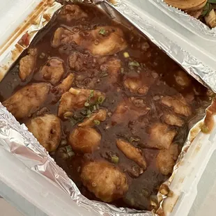 a tray of chicken and noodles