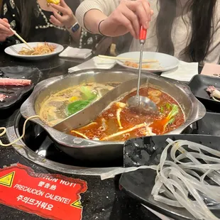 a group of people sitting at a table with food