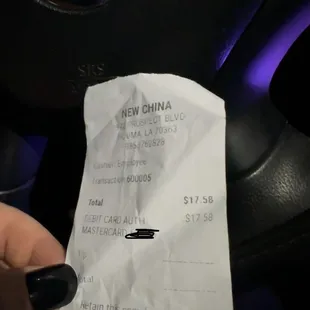 a person holding a receipt in their hand