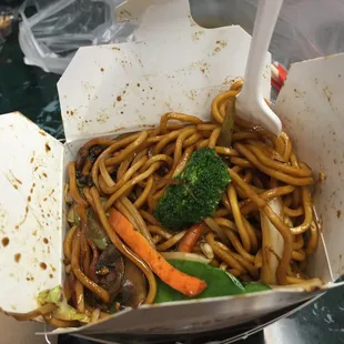 noodles and vegetables in a take out box