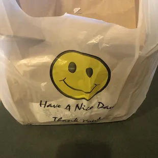 a plastic bag with a smiley face drawn on it