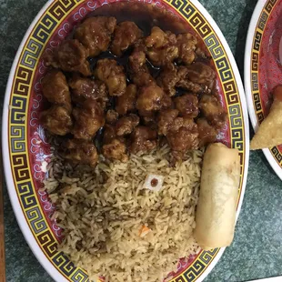 General Tso and fried rice with a spring roll.
