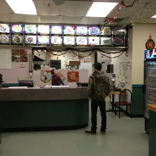 a man standing at a counter in a restaurant